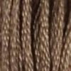 A close-up view of embroidery thread skeins, held taught vertically. The shade is a light creamy brown, like milky coffee