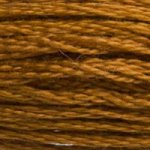 A close-up view of embroidery thread skeins, held taught horizontally. The shade is a deep yellow, like gold in the dark.