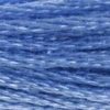 A close-up view of embroidery thread skeins, held taught horizontally. The shade is a light, dusty blue, like a cornflower.
