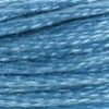 A close-up view of embroidery thread skeins, held taught horizontally. The shade is a light blue veering towards white like sun on the ocean,