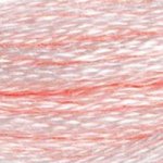A close-up view of embroidery thread skeins, held taught horizontally. The shade is a desaturated rosy pale pink tending toward white.