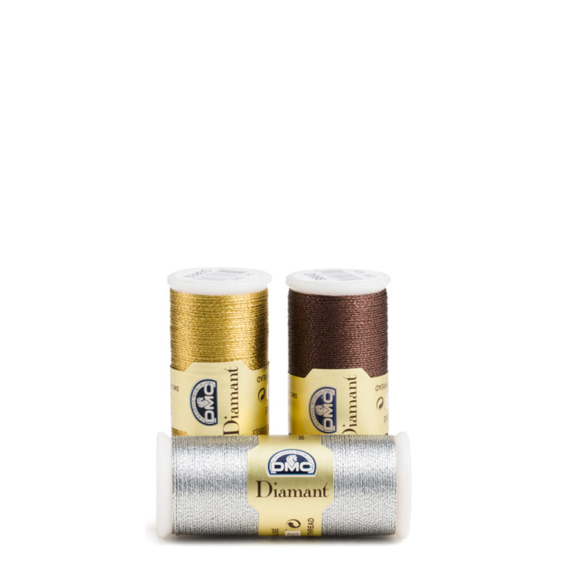Three spools of shiny thread in gold, copper and silver are arranged nicely