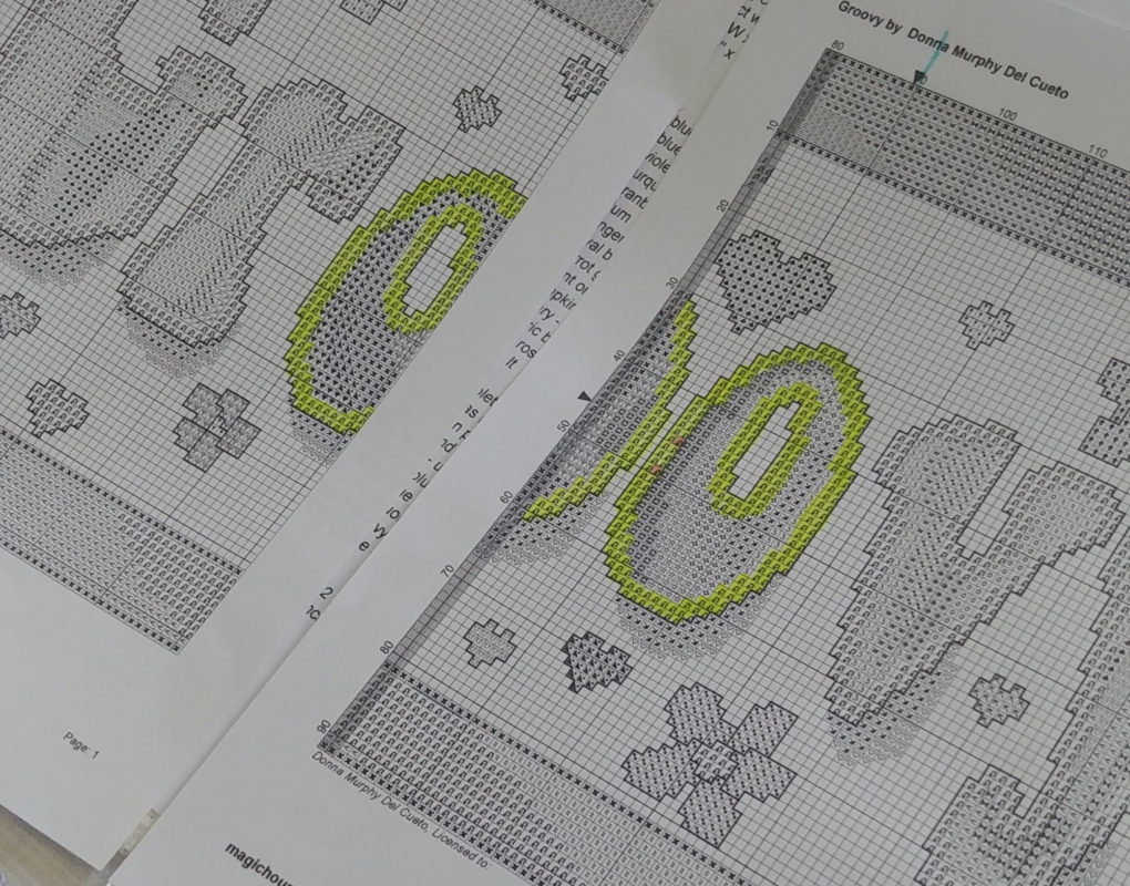 A cross stitch pattern with some squares highlighted in yellow