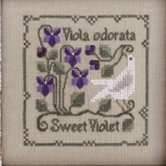 A cross stitch of a white bird and some violets