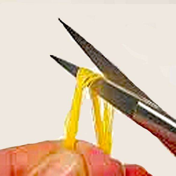 A hand holding yellow thread around the blade of a small pair cross stitching scissors ready to cut the floss