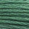 A close-up view of embroidery thread skeins, held taught horizontally. The shade is a medium green shade with subtle bluish undertones, like a mug of mint tea.