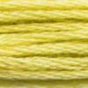 A close-up view of embroidery thread skeins, held taught horizontally. The shade is a bright yellow-green shade, like ripening wheat.