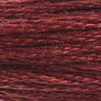 A close-up view of embroidery thread skeins, held taught horizontally. The shade is a dark shade of purplish light red, like a mudslide in clay.