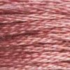 A close-up view of embroidery thread skeins, held taught horizontally. The shade is a medium light dusty rose, like a pallet of blush. 