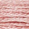 A close-up view of embroidery thread skeins, held taught horizontally. The shade is a  light dusty rose, just a bit greyer than a baby pink, like an antique baby blanket.