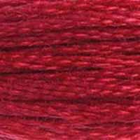 A close-up view of embroidery thread skeins, held taught horizontally. The shade is a medium dark red that works well as an earth tone too, like the red desert clay.