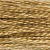 A close-up view of embroidery thread skeins, held taught horizontally. The shade is a medium dark golden brown, the colour of honey-flavoured cereal