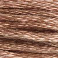 A close-up view of embroidery thread skeins, held taught horizontally. The shade is a medium sandy brown with pinkish undertones, like a wet sandcastle