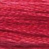 A close-up view of embroidery thread skeins, held taught horizontally. The shade is a lovely medium shade of rose red, almost like a cherry red