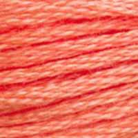 A close-up view of embroidery thread skeins, held taught horizontally. The shade is a pretty bright medium orange with pinkish undertones, like salmon sashimi.