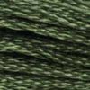 A close-up view of embroidery thread skeins, held taught horizontally. The shade is a very dark green, like a shadowed pine forest