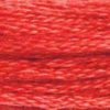 A close-up view of embroidery thread skeins, held taught horizontally. The shade is a medium dark shade of pink with a touch of orange, like watermelon gum.