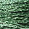 A close-up view of embroidery thread skeins, held taught horizontally. The shade is a of the most commonly used green shades. It's medium, with a hint of greyish undertones, like green mouthwash.