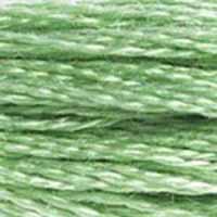A close-up view of embroidery thread skeins, held taught horizontally. The shade is a one of the most commonly used green shades. It's a  medium light shade, with a hint of greyish undertones, like a pistachio ice cream.