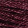 A close-up view of embroidery thread skeins, held taught horizontally. The shade is a deep dark reddish purple, like unpeeled beets