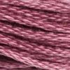 A close-up view of embroidery thread skeins, held taught horizontally. The shade is a medium purple with pinkish overtones