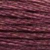 A close-up view of embroidery thread skeins, held taught horizontally. The shade is a medium dark dusty purple