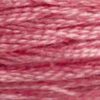 A close-up view of embroidery thread skeins, held taught horizontally. The shade is a medium dusty pink