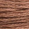 A close-up view of embroidery thread skeins, held taught horizontally. The shade is a medium dark sandy brown with a touch of brick red
