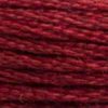 A close-up view of embroidery thread skeins, held taught horizontally. The shade is a dark wine red with a touch or brick, like a nice Merlot