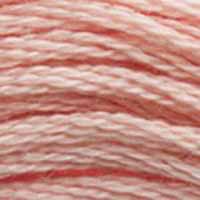 A close-up view of embroidery thread skeins, held taught horizontally. The shade is a light dusty rose pink with a hint of tan