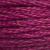 A close-up view of embroidery thread skeins, held taught horizontally. The shade is a medium purple with a touch of pink