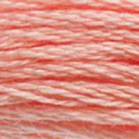 A close-up view of embroidery thread skeins, held taught horizontally. The shade is a very pretty medium true pink