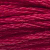 A close-up view of embroidery thread skeins, held taught horizontally. The shade is a dark purplish red