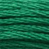 A close-up view of embroidery thread skeins, held taught horizontally. The shade is a medium bright green like grass