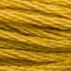 A close-up view of embroidery thread skeins, held taught horizontally. The shade is a deep golden yellow that edges toward brown