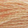 A close-up view of embroidery thread skeins, held taught horizontally. The shade is a pretty light peachy pink.