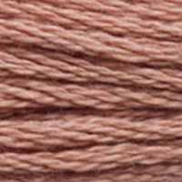 A close-up view of embroidery thread skeins, held taught horizontally. The shade is a medium light pinkish brown, like hot chocolate with lots of milk.