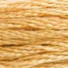 A close-up view of embroidery thread skeins, held taught horizontally. The shade is a light shade of brown with just a hint of golden tone, like coffee with cream