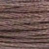 A close-up view of embroidery thread skeins, held taught horizontally. The shade is a medium dark shade of grey with a touch of pinkish purple, like rosehips gone over for winter.
