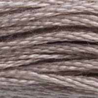 A close-up view of embroidery thread skeins, held taught horizontally. The shade is a medium shade of grey with a touch of purple, like a branch bleached on the beach.