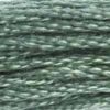 A close-up view of embroidery thread skeins, held taught horizontally. The shade is a pretty medium shade about halfway between blue and green, like a blue spruce Christmas tree but lighter