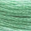 A close-up view of embroidery thread skeins, held taught horizontally. The shade is a lovely medium light green, just the colour of classical Chinese jade