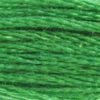 A close-up view of embroidery thread skeins, held taught horizontally. The shade is a pretty medium light true green, like a Christmas Elf's uniform