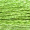 A close-up view of embroidery thread skeins, held taught horizontally. The shade is a bright light green with a light touch of yellow, like a glass of lime juice
