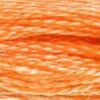 A close-up view of embroidery thread skeins, held taught horizontally. The shade is a light pretty pumpkin orange. A nice light earth-tone!