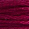 A close-up view of embroidery thread skeins, held taught horizontally. The shade is a deep burgundy red, like a fall wine