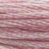 A close-up view of embroidery thread skeins, held taught horizontally. The shade is a very light purple with slight pink undertones, like strawberry milk