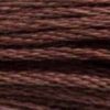 A close-up view of embroidery thread skeins, held taught horizontally. The shade is a very dark brown with reddish undertones, like hazelnut coffee