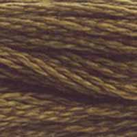 A close-up view of embroidery thread skeins, held taught horizontally. The shade is a medium dark brown with just a hint of gold or green, like fall grains