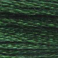 A close-up view of embroidery thread skeins, held taught horizontally. The shade is a dark beautiful green, like a deep emerald or a pine forest
